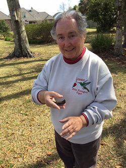 Newfield holds a banded hummingbird in 2014